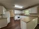 Open kitchen with white cabinets, modern appliances, and an island with a breakfast bar at 312 Yarbrough Ct, Dacula, GA 30019