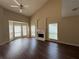 Bright living room featuring a fireplace, large windows, high ceilings, and wood flooring at 312 Yarbrough Ct, Dacula, GA 30019
