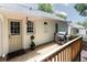 Back deck with a grill, exterior door, potted plant, and painted brick exterior at 495 Hascall Nw Rd, Atlanta, GA 30309