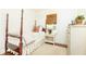 Cozy bedroom with a four-poster bed, hardwood floors, and natural light at 495 Hascall Nw Rd, Atlanta, GA 30309
