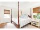 Inviting bedroom with a four-poster bed, hardwood floors, and natural light at 495 Hascall Nw Rd, Atlanta, GA 30309