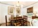 Elegant dining room featuring a wooden table with seating for six, accented by stylish lighting and artwork at 495 Hascall Nw Rd, Atlanta, GA 30309