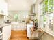 Well-lit kitchen featuring hardwood floors, marble countertops, stainless steel appliances, and plenty of natural light at 495 Hascall Nw Rd, Atlanta, GA 30309