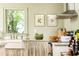Charming kitchen featuring a farmhouse sink, custom valance, and elegant decor, with a view to the outside at 495 Hascall Nw Rd, Atlanta, GA 30309