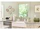 Charming kitchen featuring a farmhouse sink, marble countertops, and decorative wall plates at 495 Hascall Nw Rd, Atlanta, GA 30309