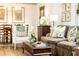 Cozy living room showcasing hardwood floors, floral pillows, and charming decor, with a glimpse of the dining area at 495 Hascall Nw Rd, Atlanta, GA 30309