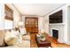 Inviting living room with hardwood floors, a fireplace, and comfortable seating, creating a warm and stylish atmosphere at 495 Hascall Nw Rd, Atlanta, GA 30309