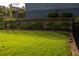 Well-maintained backyard featuring a black fence, lush green grass, and professional landscaping at 513 Forest Ln, Canton, GA 30114