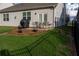 Inviting backyard with a patio, outdoor furniture, grill, and black fencing at 513 Forest Ln, Canton, GA 30114
