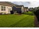 Private backyard with a black fence, green grass, and patio area with outdoor furniture at 513 Forest Ln, Canton, GA 30114