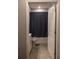 Bright bathroom with a white door, tiled floor, and a tub with shower curtain at 513 Forest Ln, Canton, GA 30114