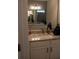Bathroom featuring dual sinks set in stone countertops, complete with a modern light fixture at 513 Forest Ln, Canton, GA 30114