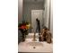 Close-up of bathroom sink with fresh flowers and neutral-colored towels at 513 Forest Ln, Canton, GA 30114