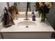 Bathroom vanity featuring a white sink, brushed nickel faucet, and decorative accents at 513 Forest Ln, Canton, GA 30114