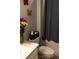 The bathroom features a bouquet of flowers adding color to the muted grays at 513 Forest Ln, Canton, GA 30114