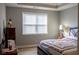 Bedroom featuring a comfortable bed and dresser with natural light from a large window at 513 Forest Ln, Canton, GA 30114
