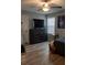Bedroom features a TV, a large dresser, and a window for natural light at 513 Forest Ln, Canton, GA 30114