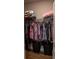 Walk-in closet with wood floor and organization system with two black big baskets at 513 Forest Ln, Canton, GA 30114