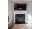 Living room with fireplace, black granite surround, and mantle with television at 513 Forest Ln, Canton, GA 30114