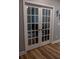 Office shown through white French doors leading to room with hard wood floors and neutral paint at 513 Forest Ln, Canton, GA 30114