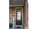 Stylish front door with glass inset and a 'Welcome' sign, set against a stone and brick facade at 513 Forest Ln, Canton, GA 30114
