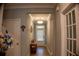 Hallway with wood floors, neutral paint, coat closet, and decorative table at 513 Forest Ln, Canton, GA 30114