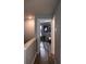 Hallway leading to a bedroom with hardwood floors and gray walls at 513 Forest Ln, Canton, GA 30114