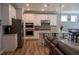 Modern kitchen featuring white cabinets, stainless steel appliances, and a granite countertop island at 513 Forest Ln, Canton, GA 30114