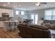 Open-concept space with an island kitchen, a dining area, and a bright living room with hardwood floors at 513 Forest Ln, Canton, GA 30114