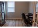 View of office space featuring a cabinet with glass shelves, a chair, and a desk at 513 Forest Ln, Canton, GA 30114