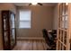 The home office has a modern desk, chair, display cabinet, and a window at 513 Forest Ln, Canton, GA 30114