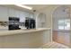 Kitchen with stainless steel appliances and breakfast bar, connects to a sunny living area at 6715 Biscayne Blvd, Rex, GA 30273