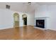 Bright living room with hardwood floors and a cozy fireplace, open to the kitchen area at 6715 Biscayne Blvd, Rex, GA 30273