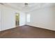 Large main bedroom features neutral walls and carpet floors with a view to the connected bathroom at 6715 Biscayne Blvd, Rex, GA 30273