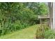View of the lush backyard and small elevated deck with mature trees at 950 Mill Creek Ave, Canton, GA 30115