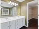 This bathroom has double sinks, a large mirror, and access to a walk-in closet at 950 Mill Creek Ave, Canton, GA 30115