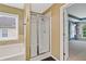 This bathroom features a glass enclosed shower, tub, and window at 950 Mill Creek Ave, Canton, GA 30115