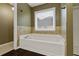 This bathroom features a large tub with jets and a window at 950 Mill Creek Ave, Canton, GA 30115