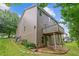 Exterior angle view of a two-story home with a small balcony and manicured lawn at 950 Mill Creek Ave, Canton, GA 30115