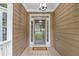 Covered front porch with a glass door entrance and 'Welcome' doormat at 950 Mill Creek Ave, Canton, GA 30115