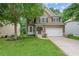 Charming two-story home featuring a well-manicured lawn, a two-car garage, and beautiful landscaping at 950 Mill Creek Ave, Canton, GA 30115