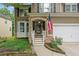 Inviting front porch with stone accents, white stairs and a charming American flag at 950 Mill Creek Ave, Canton, GA 30115