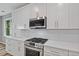 Kitchen featuring stainless steel appliances, white cabinets, and a gas range at 950 Mill Creek Ave, Canton, GA 30115
