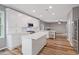 Spacious kitchen featuring white cabinets, stainless steel appliances, and a large island at 950 Mill Creek Ave, Canton, GA 30115