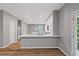 Kitchen showcasing white cabinets, stainless steel appliances, quartz countertops, and wood floors at 950 Mill Creek Ave, Canton, GA 30115