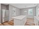Open concept kitchen with stainless steel refrigerator and a kitchen island at 950 Mill Creek Ave, Canton, GA 30115