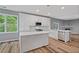 Open concept kitchen with white cabinets, stainless steel appliances, and a kitchen island at 950 Mill Creek Ave, Canton, GA 30115