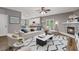 Open living room boasts wood floors, fireplace, and open floor plan at 950 Mill Creek Ave, Canton, GA 30115