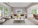 Cozy living room with neutral decor, hardwood floors, a bay window and lots of natural light at 950 Mill Creek Ave, Canton, GA 30115