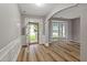 Sunlit living room featuring hardwood floors, fresh paint, a bay window, and elegant trim at 950 Mill Creek Ave, Canton, GA 30115